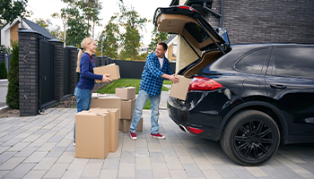 family moving into a new home unloading car