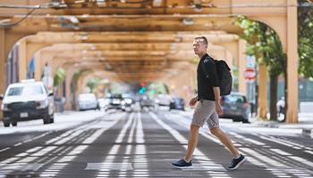 a non car owner walking across street
