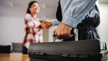 homeowner shaking hands with a repair person
