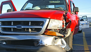 red truck involved in an car accident with police in the background - most common insurance claims