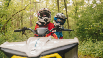 Two ATV riders on a trail