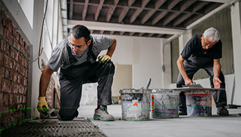 two tile installers working together