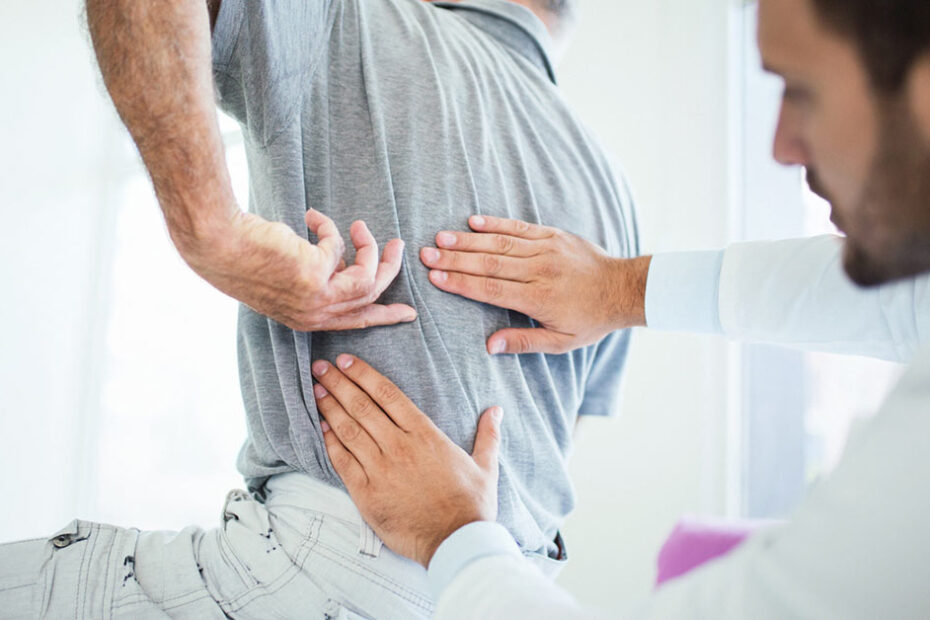 doctor examine back injury - workers' comp