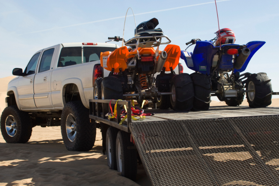 truck with ATVs on the bed