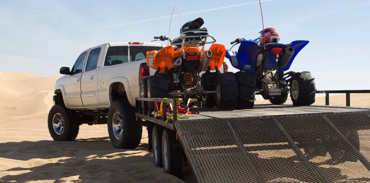 truck with ATVs on the bed