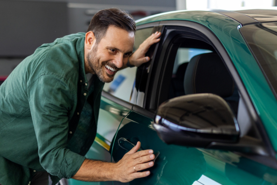 person looking at new car
