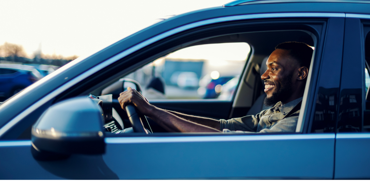 happy person driving in their car