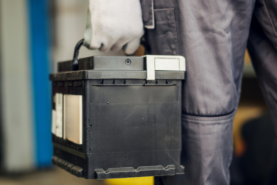 car battery being moved to be installed