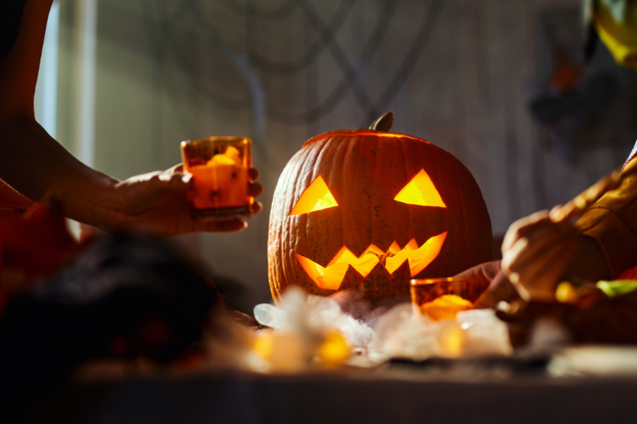 halloween decorated table with a carved pumpkin in the center